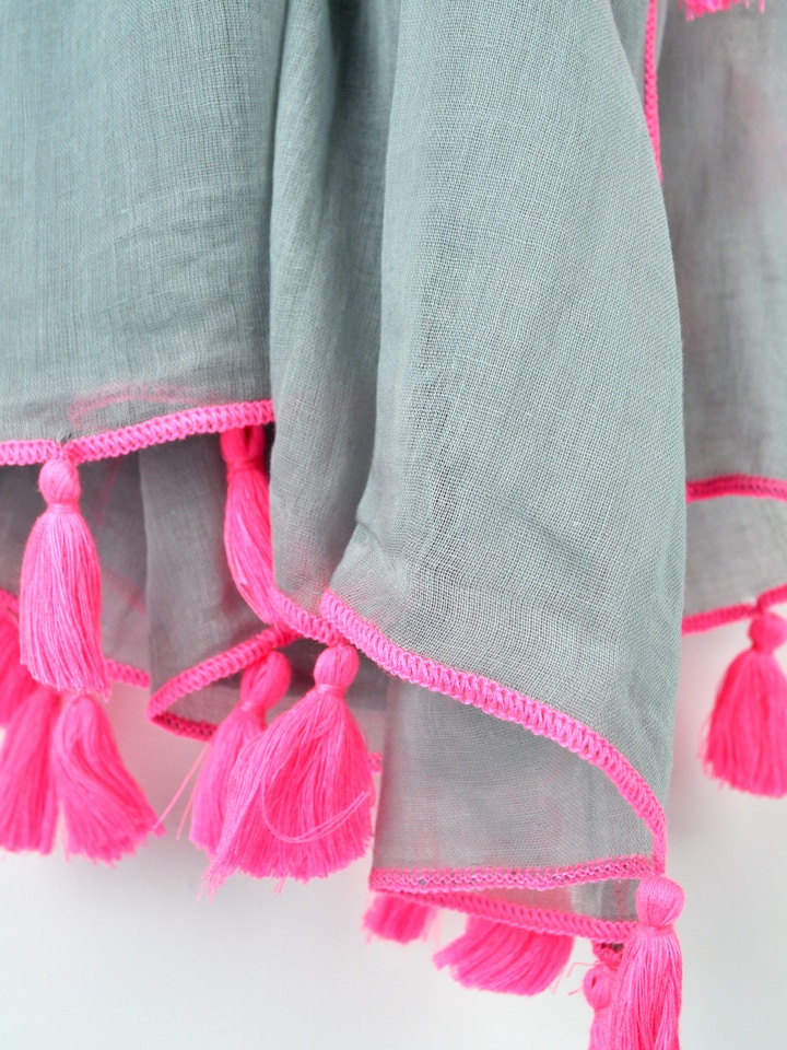 Tilly bright pink tassel scarf detail