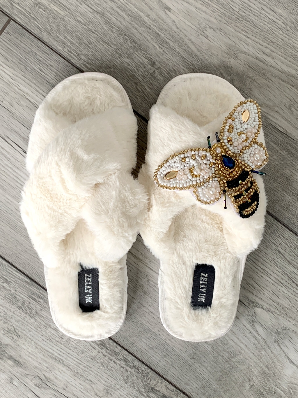 Cream slippers with bee embellishment