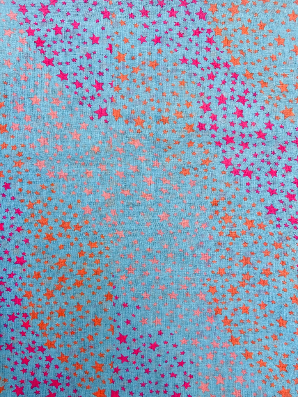 blue scarf with orange and pink small stars closeup
